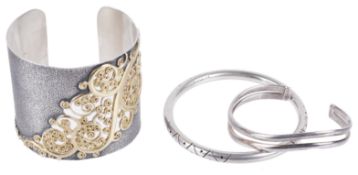 An attractive contemporary silver cuff bracelet and two silver bracelets