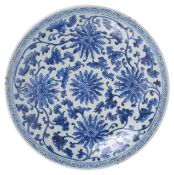 A large Chinese 19th century blue and white charger well painted with scrolling anemones and