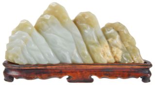 A Chinese late 19th century carved jade scholars mountainmounted on fitted carved hardwood stand