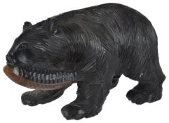 A German Black Forrest bear with fish the bear realistically carved in walking pose with fish