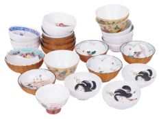 A mixed collection of early 20th century Japanese saki bowlswith various painted scenes including