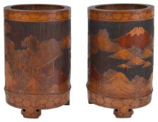 A pair of early 20th century Chinese bamboo brush potsthe cylindrical pots carved in relief with