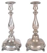 A pair of Continental silver plated candlesticksthe foliate embossed drip trays above baluster