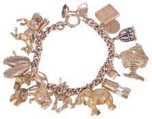 A heavy rose gold curb link charm braceletthe 9ct gold bracelet hung with an interesting variety