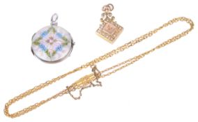 A delicate continental guilloche hinged enamel picture locket having central rose within foliate