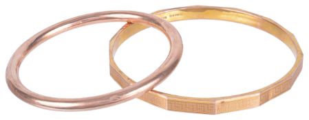 An early 20th century 9ct gold gold 'slave' bangle and a rose gold banglethe arm bangle with key