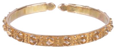 An early 20th century rose metal bangle of unusual raised floret designeach floret with bead work