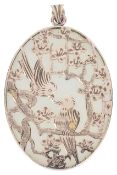 A Continental Chinese oval jade and gold overlay 'lovebirds' pendant,the polished pale celadon