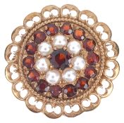A gold mounted garnet and pearl set cluster broochthe circular brooch having central garnet within a
