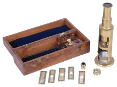 A mid 19th century brass drum microscope in fitted casewith two objectives, lenses and five specimen