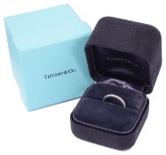 A Tiffany & Co Legacy platinum and diamond eternity wedding ring with channel set diamonds, complete