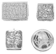 Three Contemporary silver pill boxes, 20th centurytwo embossed with flower heads and the other