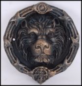 A vintage style, 20th century cast iron lion's head door knocker. Measures 28cms wide.