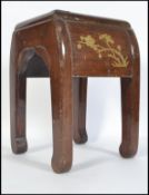 A Chinese wood stool of quatrefoil form, decorated