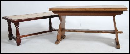 A 20th century oak coffee table in the Quaker style together with a mahogany effect tiled top coffee