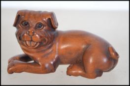 A Japanese fruitwood carved netsuke in the form of