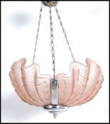 An Art Deco peach molded glass shell with ceiling