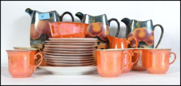 A vintage 20th century graduating set of three lustre jugs together with a lustre six person tea
