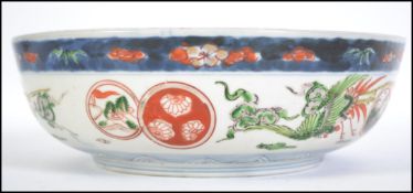 A 19th century Chinese Imari bowl with blue and white glaze having geometric pattern borders with