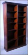 A large Regency revival mahogany double bookcase of upright form having plinth base and flared