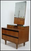 A 1970's retro teak wood dressing chest of drawers / table. The chest with a series of drawers