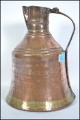 A 19th century hand beaten copper and brass jug of