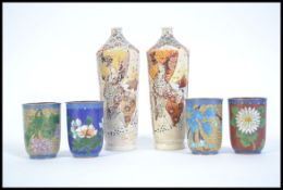 A pair of Japanese Satsuma bottle vases together with four enameled cloisonne  drinking beakers.
