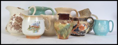A collection of vintage 20th century water jugs by various makers to include Royal Doulton, Royal