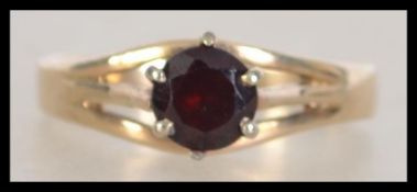 An Art Deco 9ct gold and silver ring set with a red stone  Marked 9ct and Sil. Tests 9ct and silver.