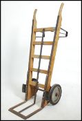 A large mid century Industrial pair of sack trucks