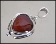 A decorative ladies silver fob in the form of a he