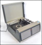 A vintage 1960's Bush portable four speed record player. Having a grey vinyl case with single