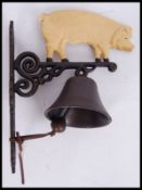A vintage style, 20th century cast iron pig bell. Measures 35cms tall.