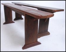 A near pair of 19th century French refectory pig benches. Each with shaped single plant tops of