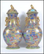 A good pair of late 19th / early 20th century lidded Chinese vases. Each vase being twin handled