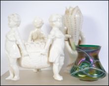 A 20th century ceramic glazed Parian ware type centrepiece rio of cherubs / putti's together with