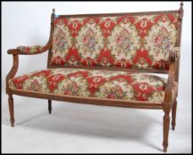An early 20th century oak French Canape sofa raise