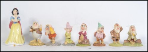 A collection of Royal Doulton Walt Disney Snow White & The Seven Dwarves figurines. Each being