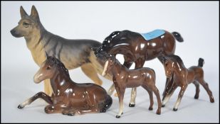 A collection of four Beswick horses and fouls toge