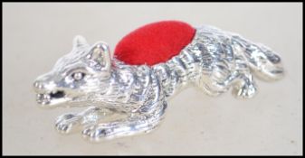 A sterling silver pin cushion in the form of a fox