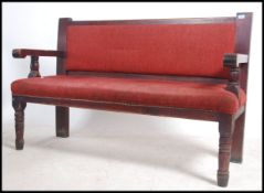 A mid century solid wood municipal railway / train station waiting room interior bench seat with