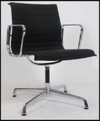 A 20th century retro style Eames chrome and black fabric r upholstered shaped office swivel chair