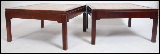 A pair of retro 20th century dark teak and tile top coffee - occasional tables Each raised on