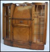 A vintage mid 20th century Art Deco light oak bureau with drop front, three drawers and two