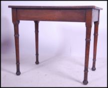 A 19th century oak writing table  side table desk being raised on turned legs with fitted frieze