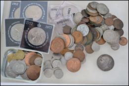 A collection of coins to include a silver crown with Victorian young bust 1844, military tokens,