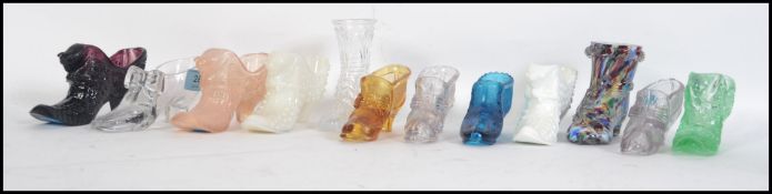 Twelve novelty pressed glass ladies shoes / boots of varying styles and ages Measures 10cms high.