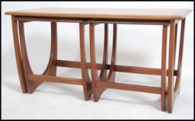 A 1970's retro G-Plan teak wood ' Fresco ' long john nest of tables / coffee table. Raised on shaped