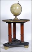 A 20th century Empire revival  terrestrial globe  table being raised on reeded column supports