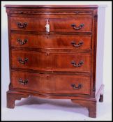 A Georgian style mahogany bow fronted bachelors chest of drawers being raised on bracket feet. Above